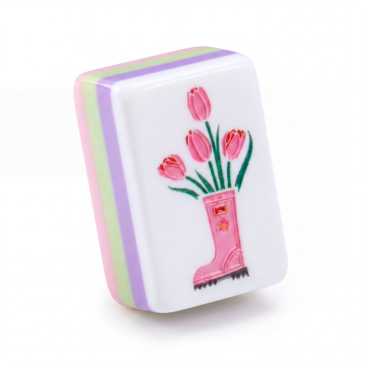 Single Bloomsbury mahjong tile showing pink tulips in a rain boot and the purple, green and pink layered edge