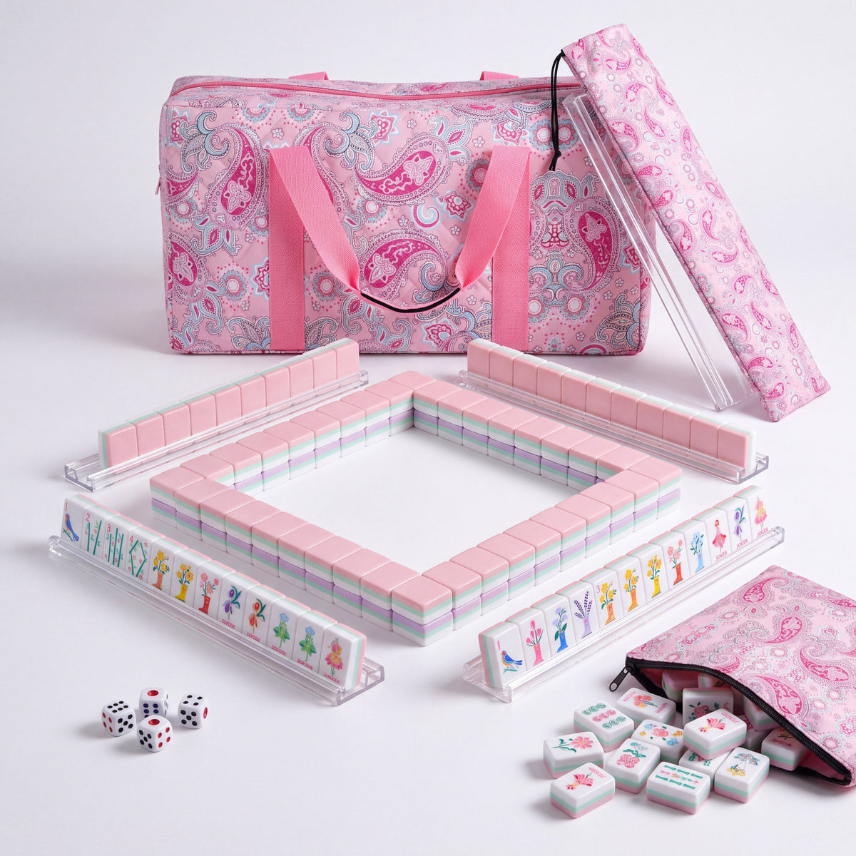 Bloomsbury American mahjong starter kit with pale pink backed tiles walled inside four clear racks, a quilted pink paisley tote, drawstring rack sleeve and zippered tile pouch