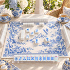 Blue Willow mahjong tiles set up for a game on a blue-and-white chinoiserie mat