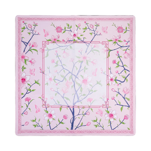 Pink magnolia mahjong mat on soft pink with a rose Greek key frame, shown flat from above on white