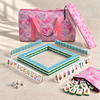 Merry Christmas American mahjong starter kit with candy-striped tile walls inside four clear racks, a quilted pink paisley tote, drawstring rack sleeve and zippered tile pouch