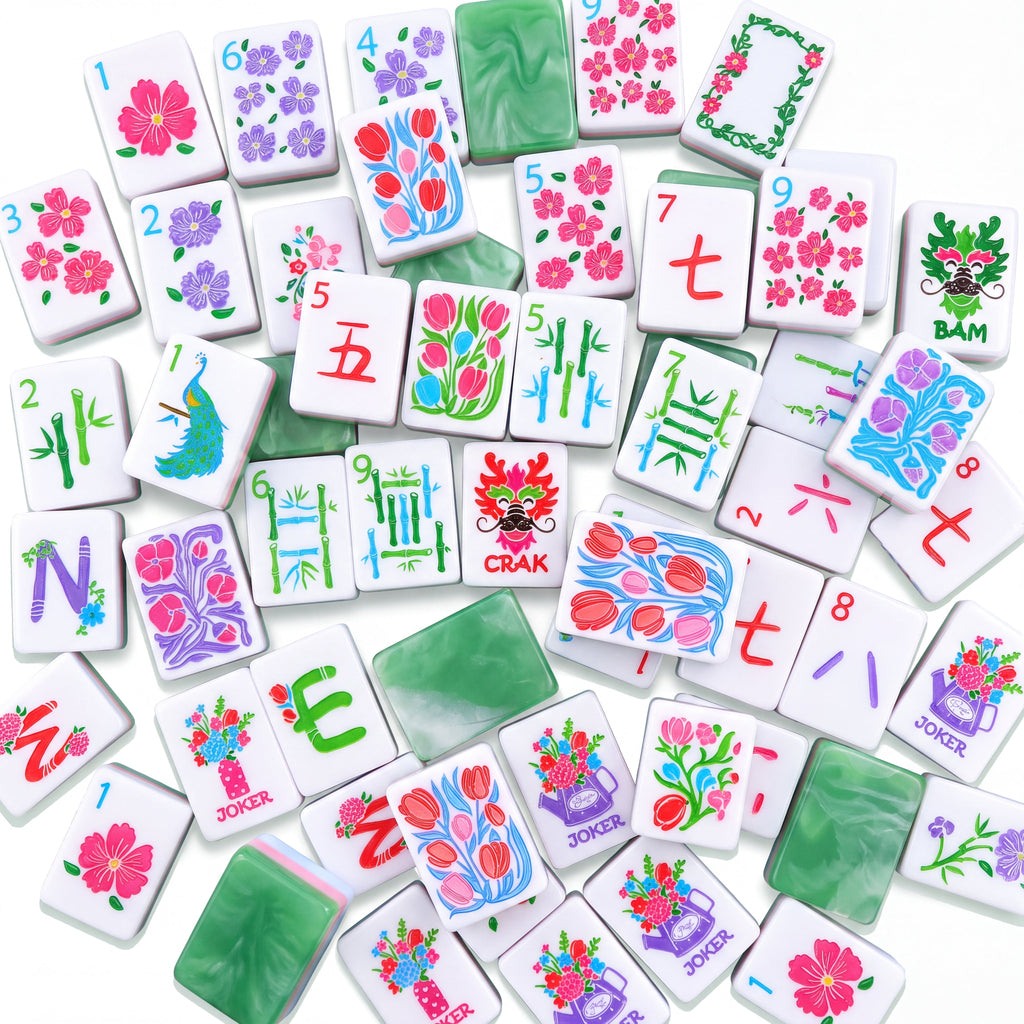 Empress American mahjong tiles scattered face up and face down, showing marbled jade backs and pink and green layered edges