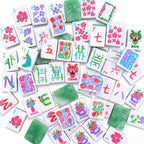 Empress American mahjong tiles scattered face up and face down, showing marbled jade backs and pink and green layered edges