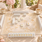 Gilded Crane mahjong tiles set up for a game on a gold and cream chinoiserie mat