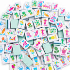 Key West American mahjong tiles scattered face up and face down, showing mint green backs and layered teal edges