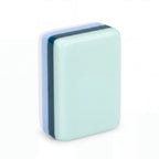 Single Key West mahjong tile from the back, showing the mint green back and striped resin edge