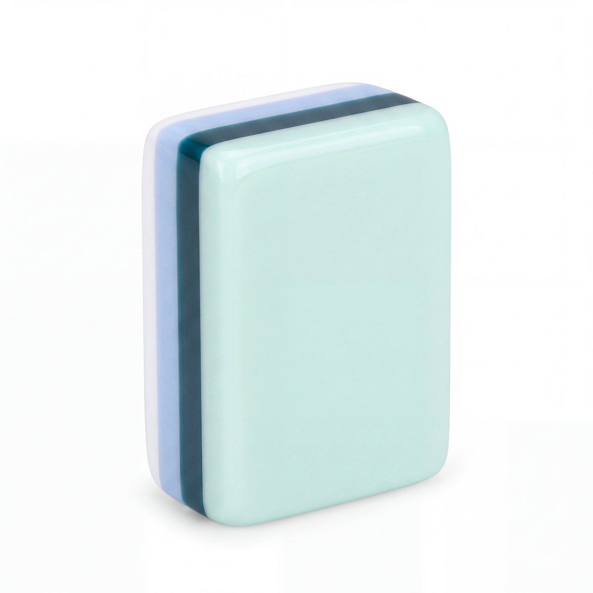 Single Key West mahjong tile from the back, showing the mint green back and striped resin edge