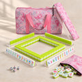 Limoncello American mahjong starter kit with lime green backed tiles walled inside four clear racks, a quilted pink paisley tote, drawstring rack sleeve and zippered tile pouch