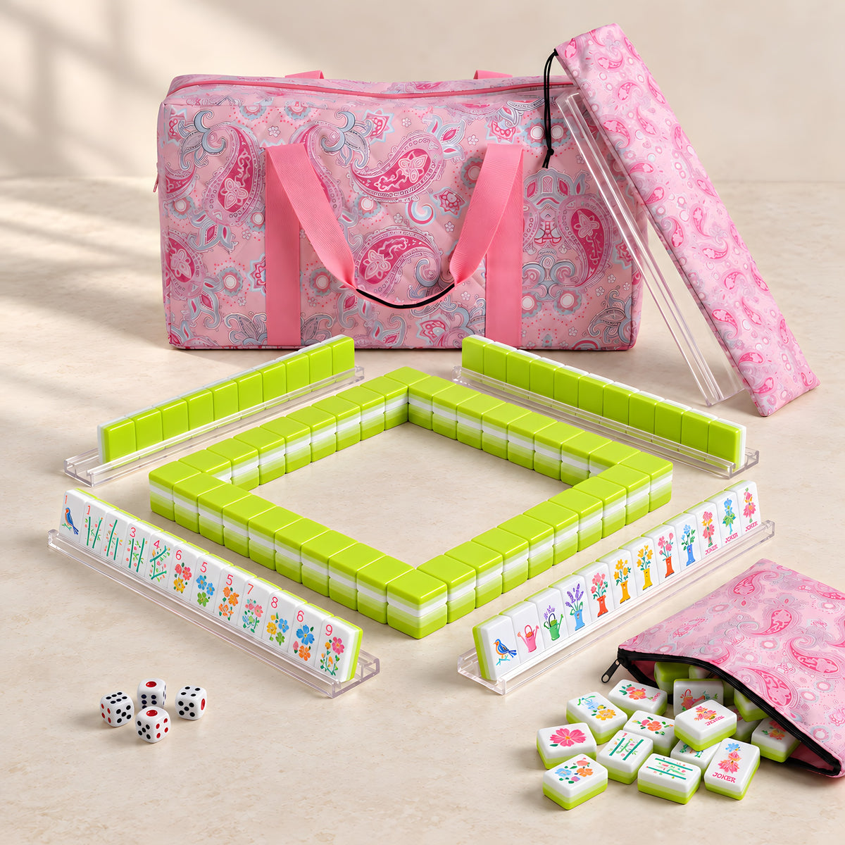 Limoncello American mahjong starter kit with lime green backed tiles walled inside four clear racks, a quilted pink paisley tote, drawstring rack sleeve and zippered tile pouch