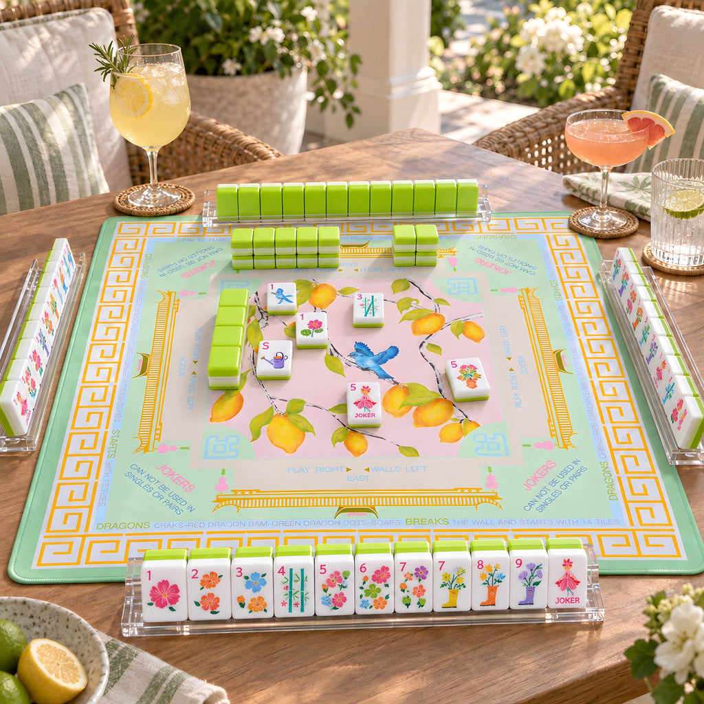 Limoncello American mahjong tiles set up for a game on a lemon print mat on a sunny terrace