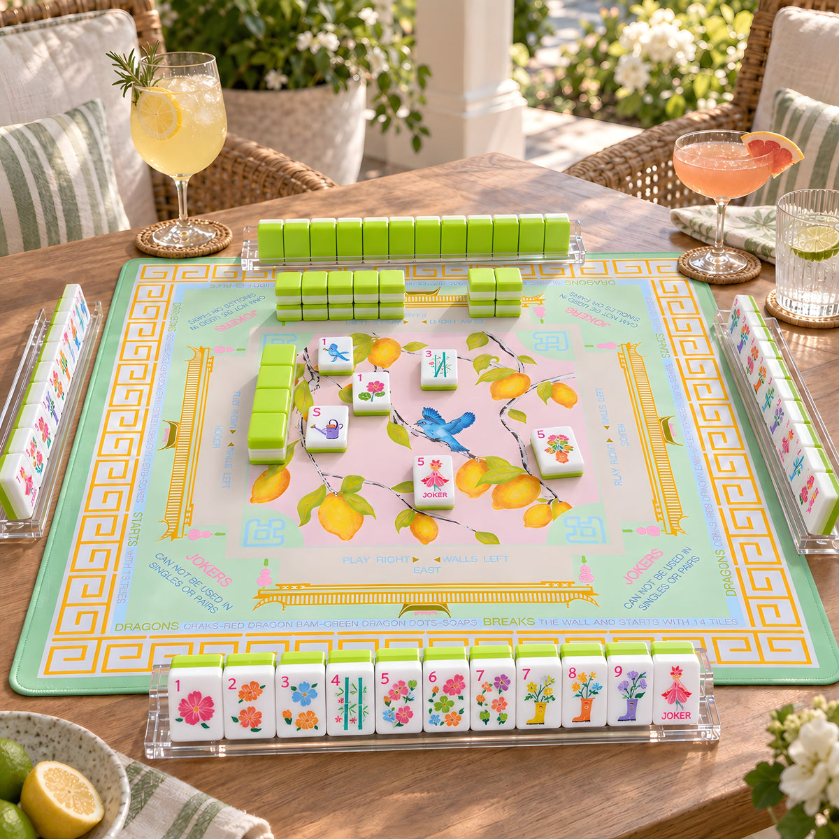 Limoncello American mahjong tiles set up for a game on a lemon print mat on a sunny terrace