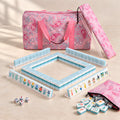 Lotus Pond American mahjong starter kit with aqua tile walls inside four clear racks and a quilted pink paisley carrying set