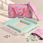 Mermaid American mahjong starter kit with pearly aqua backed tiles walled inside four clear racks, a quilted pink paisley tote, drawstring rack sleeve and zippered tile pouch