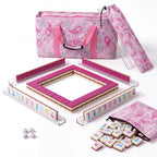 Palm Beach Pink American mahjong starter kit with magenta backed tiles walled inside four clear racks, a quilted pink paisley tote, drawstring rack sleeve and zippered tile pouch
