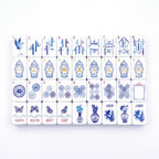Porcelain American mahjong tiles laid out in full, with blue and white ginger jar craks, bamboo bams and porcelain medallion dots