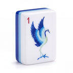 Single Porcelain mahjong tile showing the blue and white crane and the pale blue and cobalt layered edge