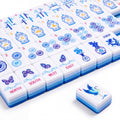Porcelain American mahjong tiles in rows, showing the blue and white ginger jar craks, bamboo bams, porcelain medallion dots, butterfly winds and the crane joker