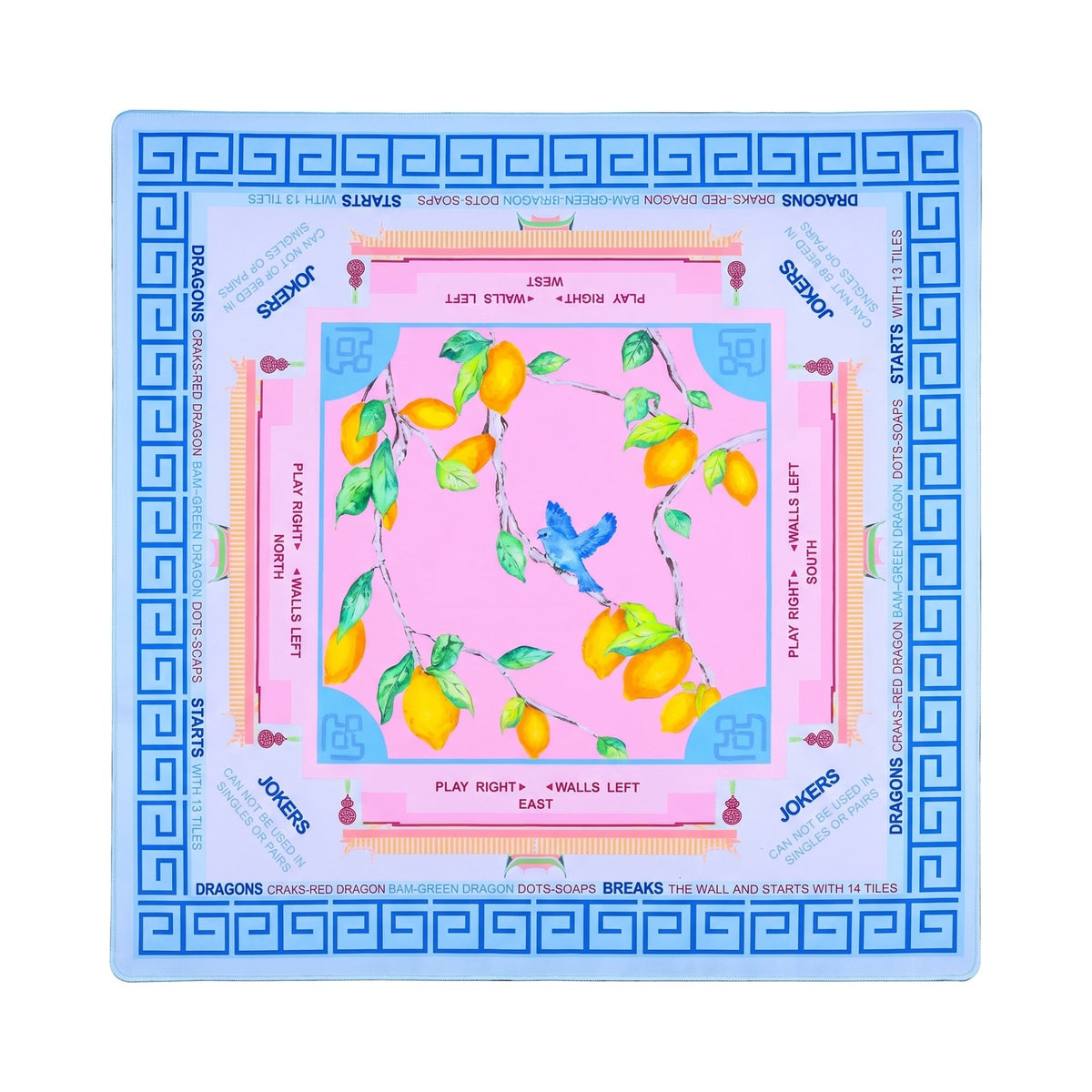 Bubblegum pink lemon branch mahjong mat with a cobalt Greek key border, shown flat from above on white