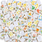 Princess Pearl American mahjong tiles scattered face up and face down, showing pearly white backs