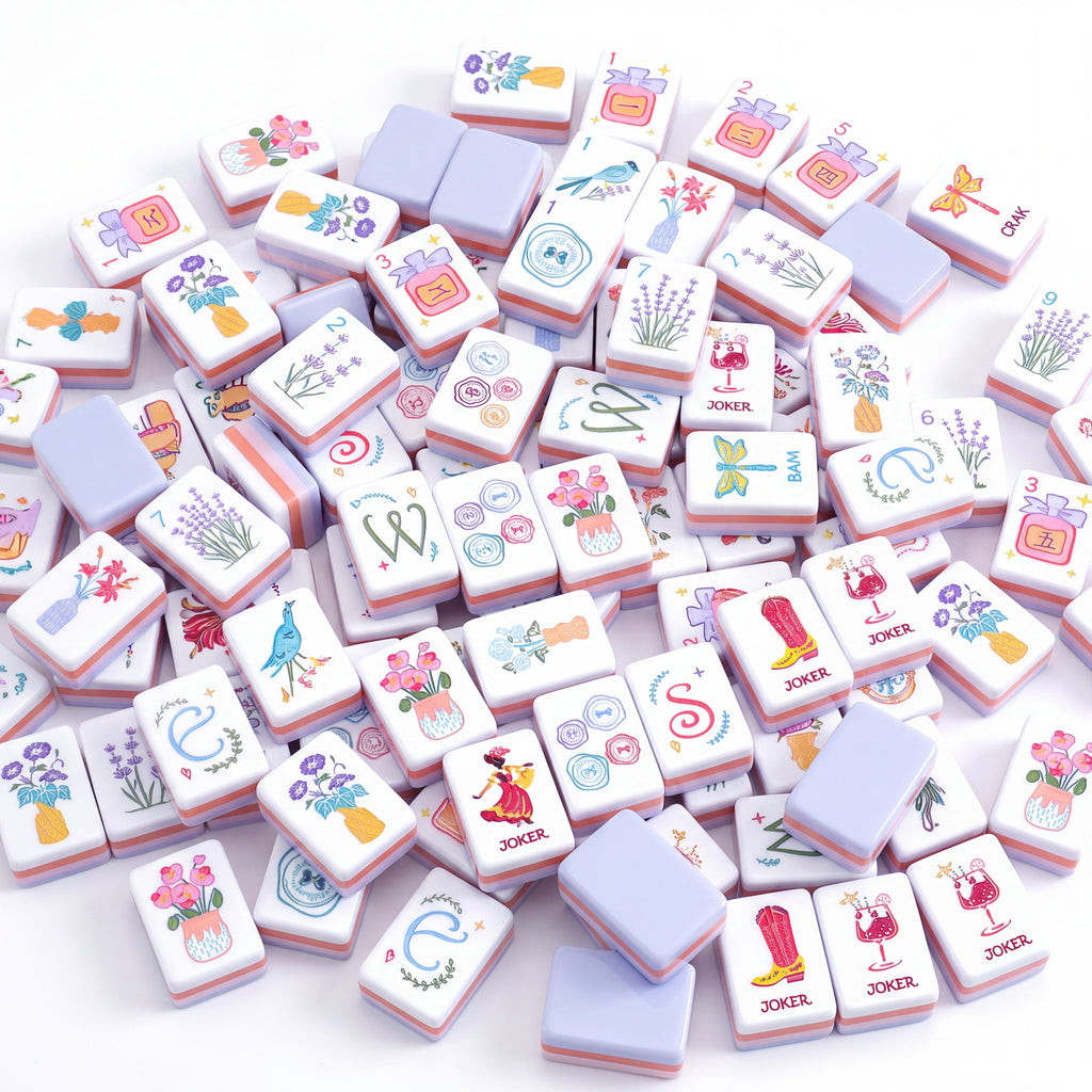 Violette American mahjong tiles scattered face up and face down, showing pale lavender backs and coral layered edges