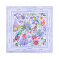 Watercolor garden mahjong mat with hydrangeas, passionflowers and a macaw, shown flat from above on white